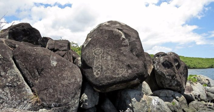 This is an image of a petroglyph, or rock carving in Ceiba, Puerto Rico. It sits beside the shore of Ensenada Honda (Deep Cove).