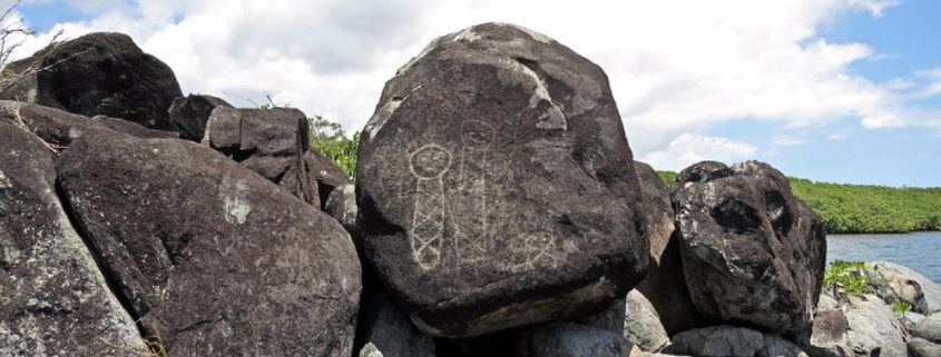 This is an image of a petroglyph, or rock carving in Ceiba, Puerto Rico. It sits beside the shore of Ensenada Honda (Deep Cove).
